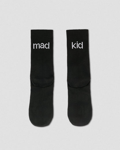 OG 01 black socks back flatlay — black socks showing “mad kid” wordmark on heel area