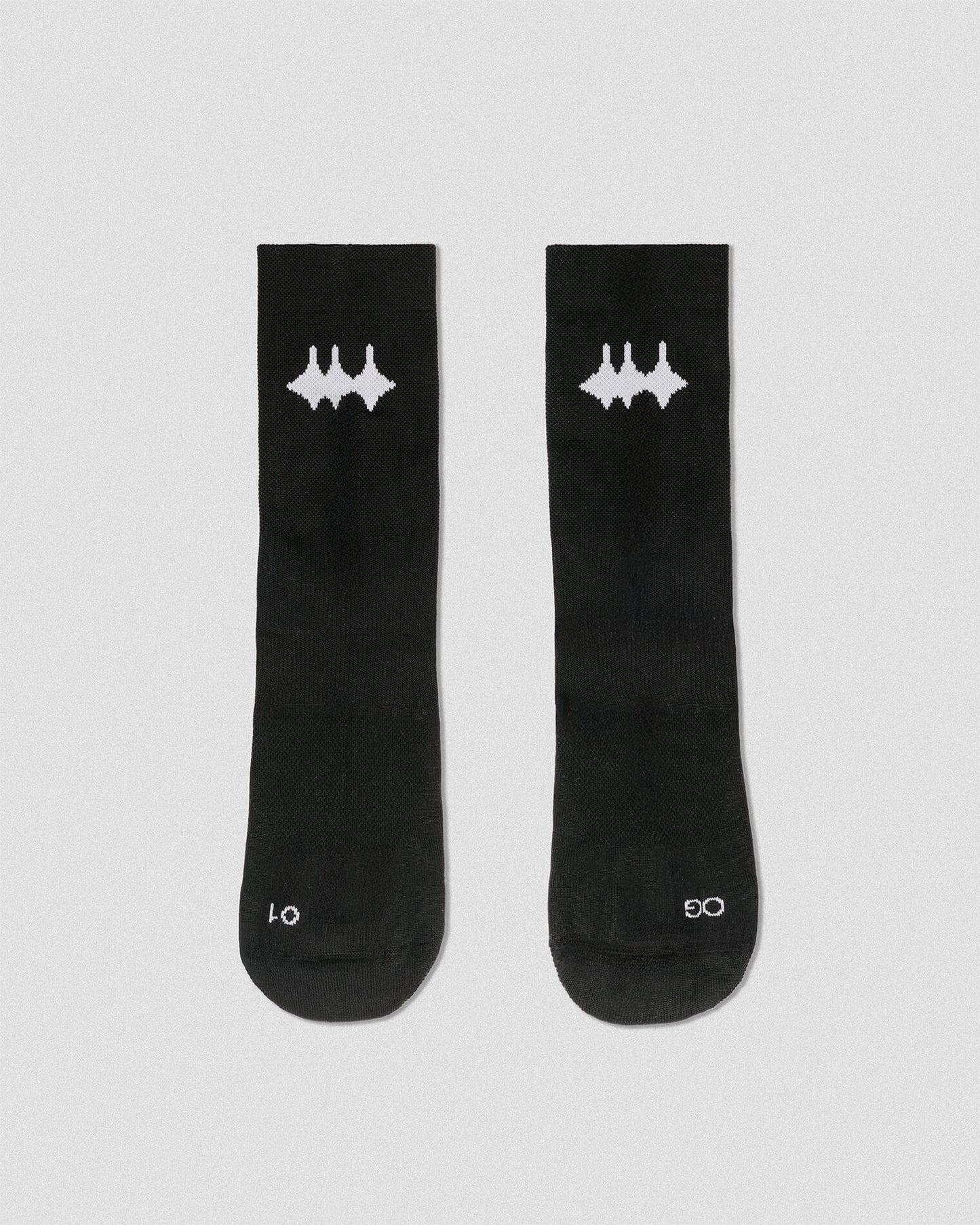 OG 01 black socks front flatlay — black technical socks with contrasting white Madkid logo