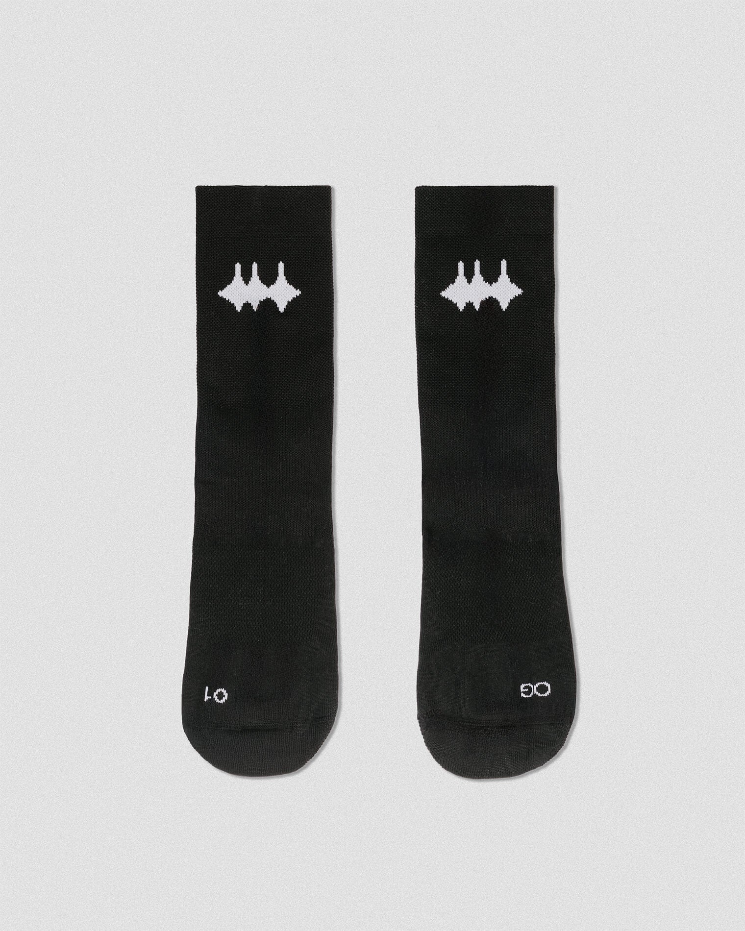 OG 01 black socks front flatlay — black technical socks with contrasting white Madkid logo