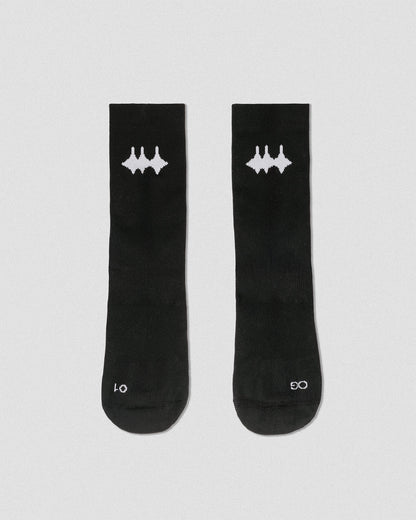 OG 01 black socks front flatlay — black technical socks with contrasting white Madkid logo