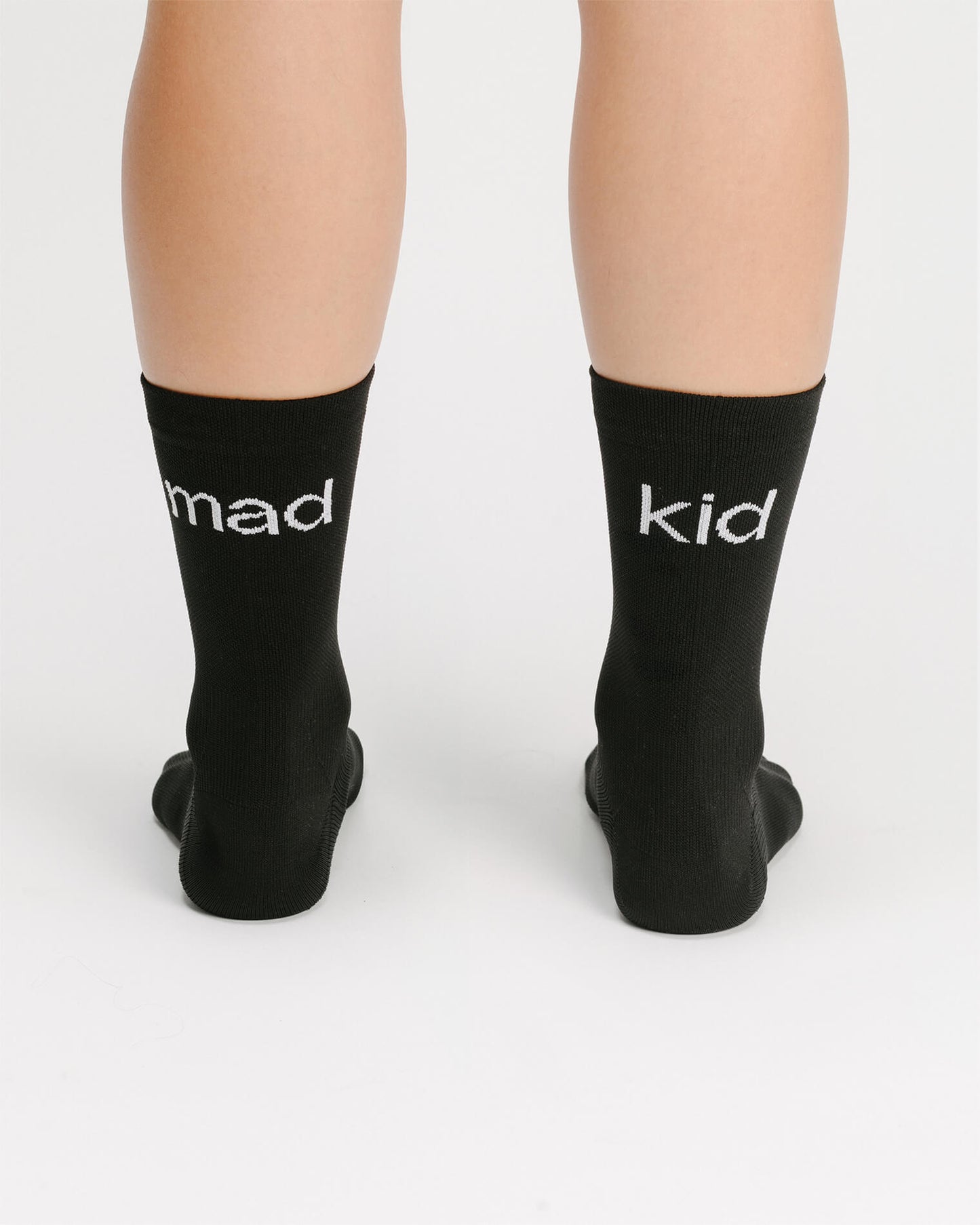 OG 01 black socks worn back on model — madkid logo visible at the back of socks