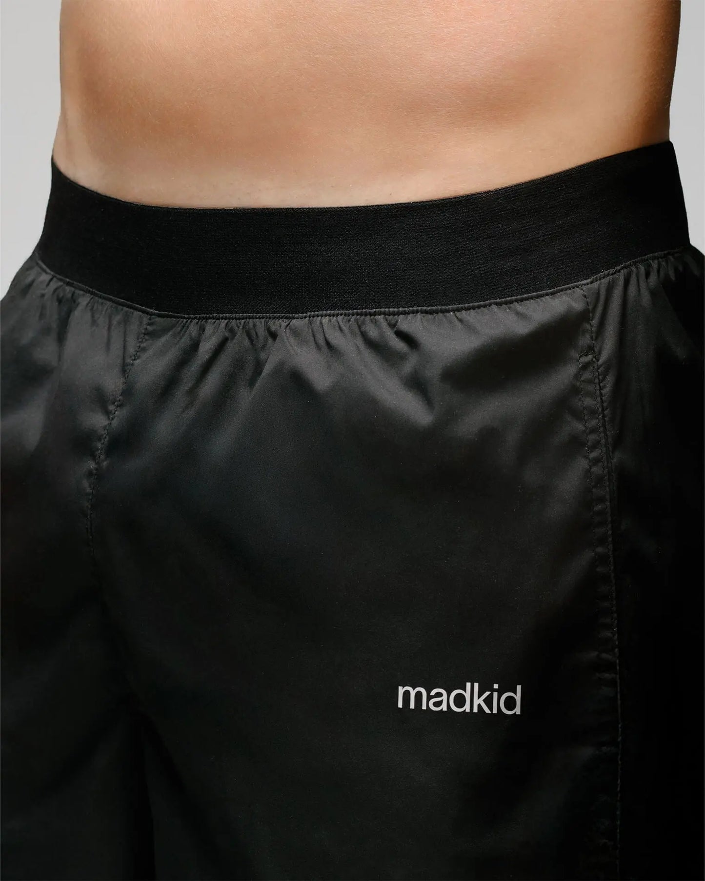 Detail 4 of OG 01 men’s shorts — close-up of Madkid logo and soft elastic waistband for comfort