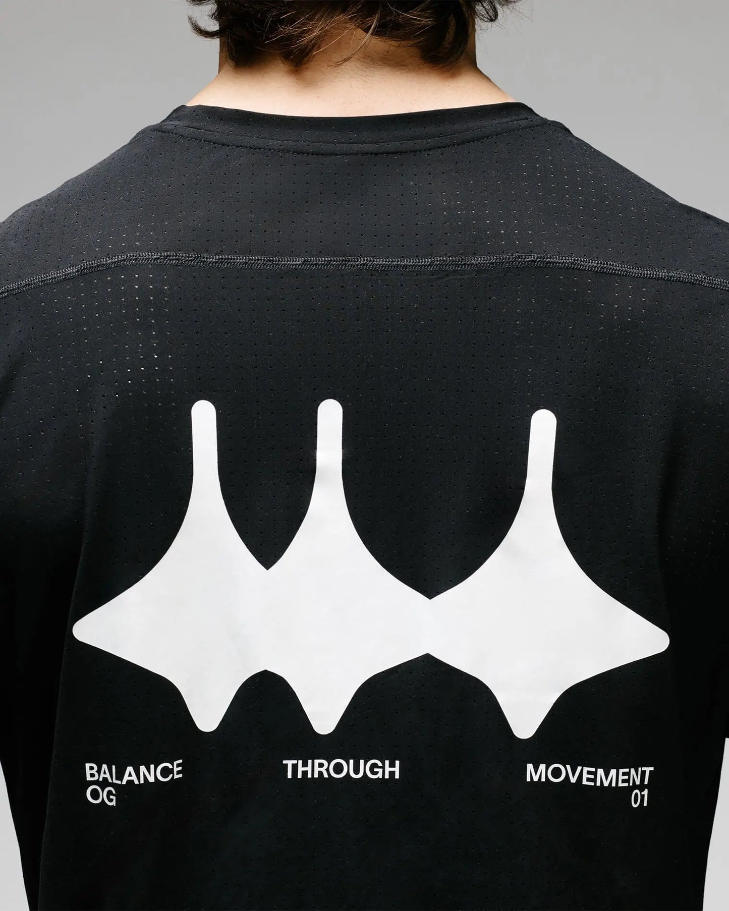 Detail of OG 01 men’s tee — Madkid crown logo on technical fabric