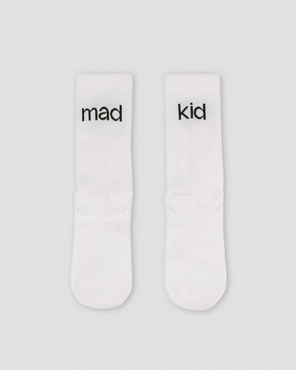 OG 01 white socks back flatlay — white athletic socks showing madkid lettering on back side