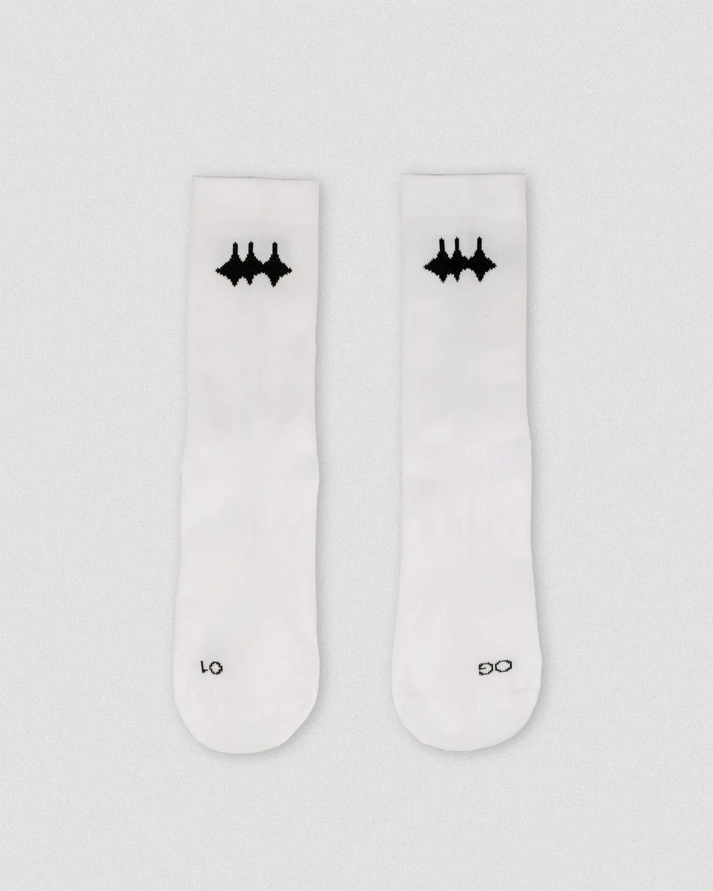 OG 01 white socks front flatlay — white performance socks with black Madkid logo on front, clean background