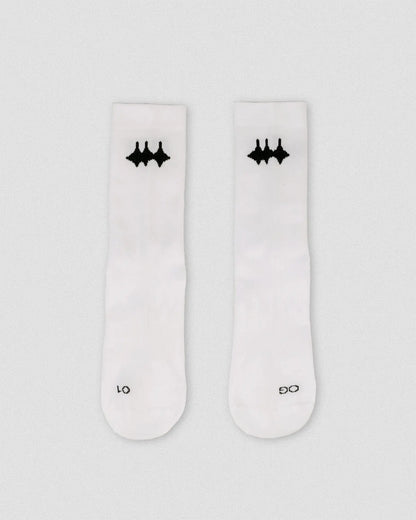OG 01 white socks front flatlay — white performance socks with black Madkid logo on front, clean background