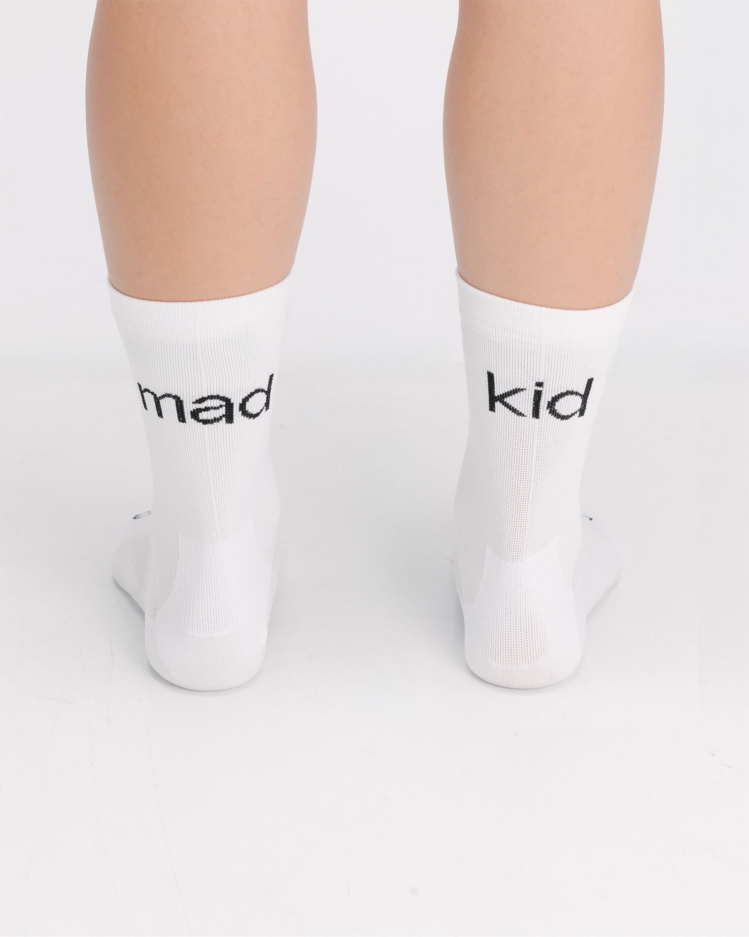 OG 01 white socks worn back on model — madkid text visible on back of socks over heel