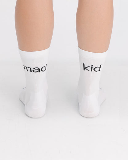 OG 01 white socks worn back on model — madkid text visible on back of socks over heel