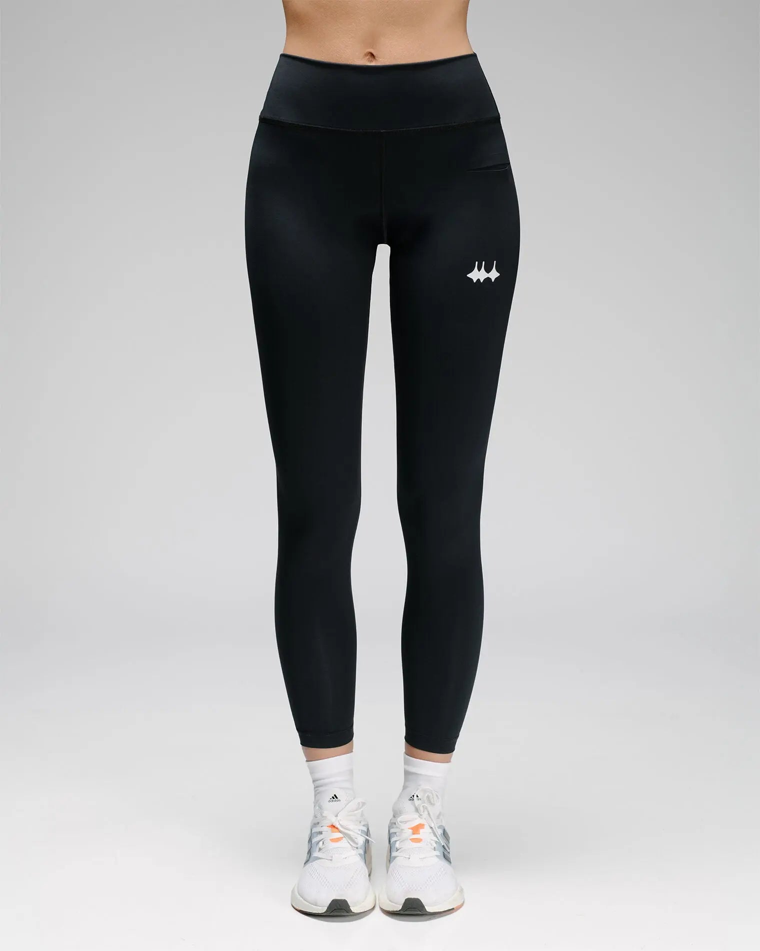 OG 01 women’s performance leggings front on model — high-waisted fit and reflective logo visible on front leg