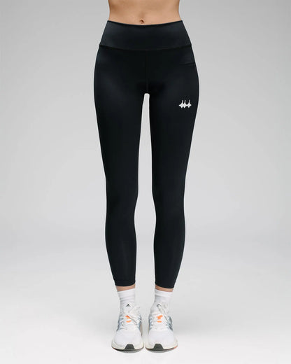 OG 01 women’s performance leggings front on model — high-waisted fit and reflective logo visible on front leg
