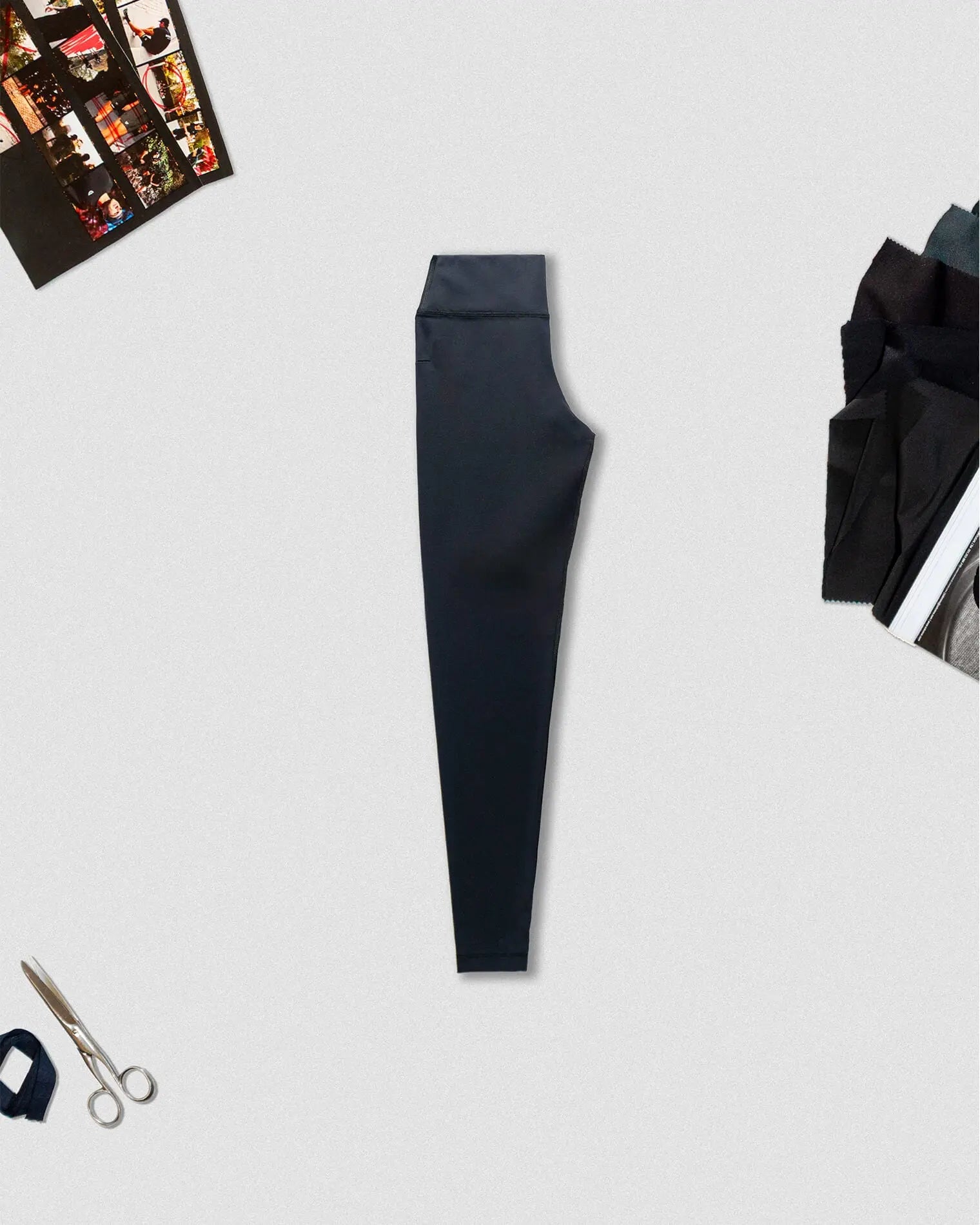 OG 01 women’s performance leggings side B flatlay — black high-waist leggings viewed from opposite angle with props by Madkid
